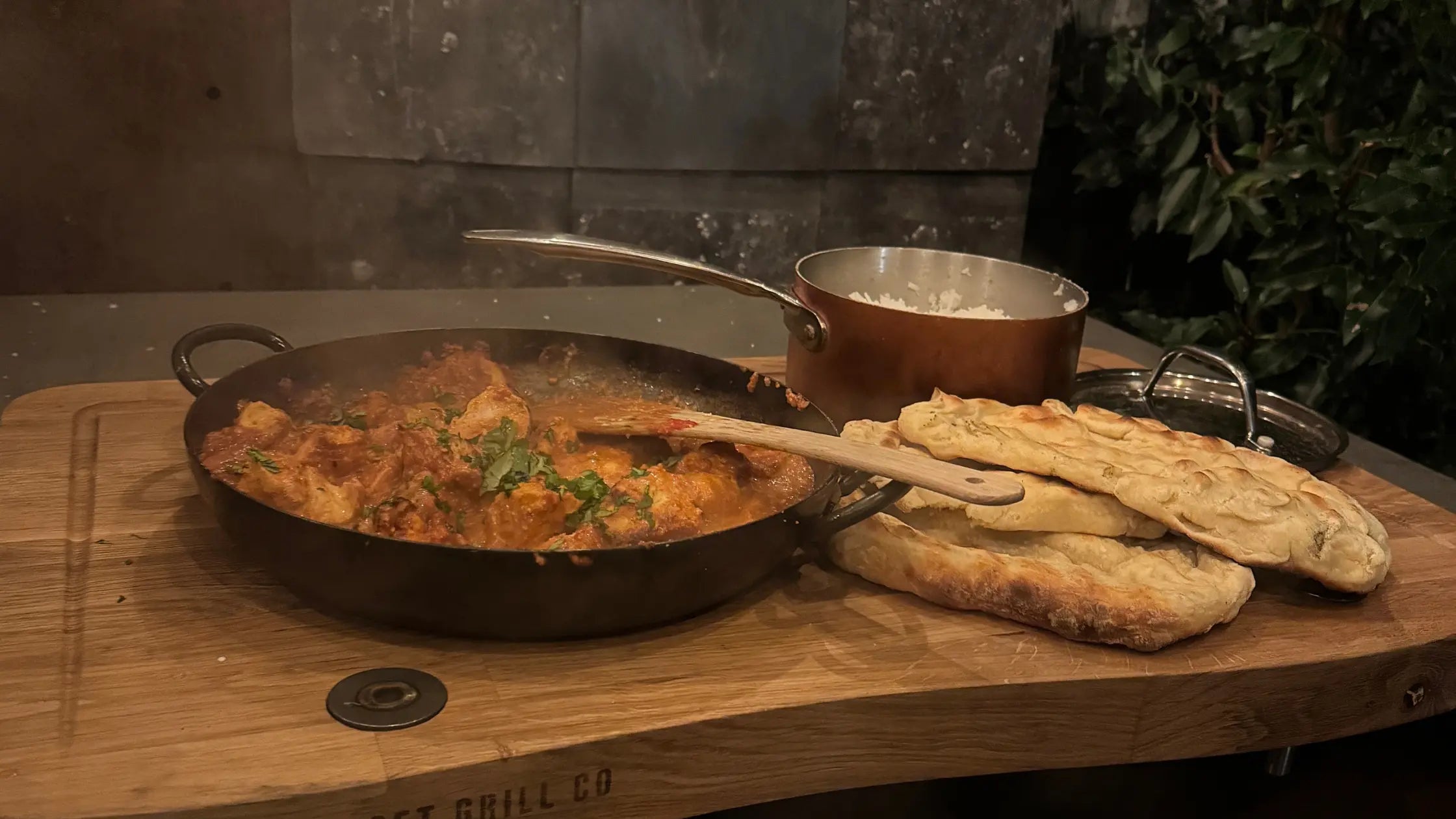 Butter Chicken, with nana breads and rice all cover over fire