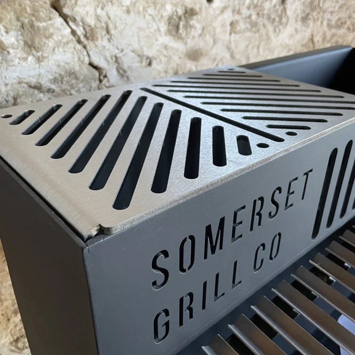 Metal grey grill accessory with ventilation slits and Somerset Grill Co branding