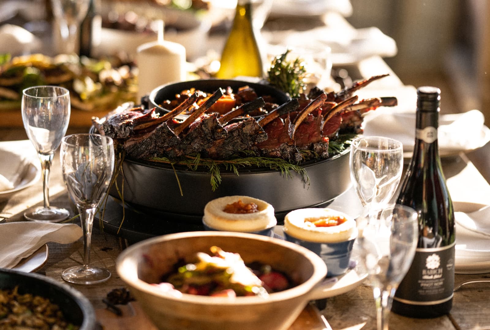 A Table filled with a woodfired Feast Cooked on a Argentinean Grill 