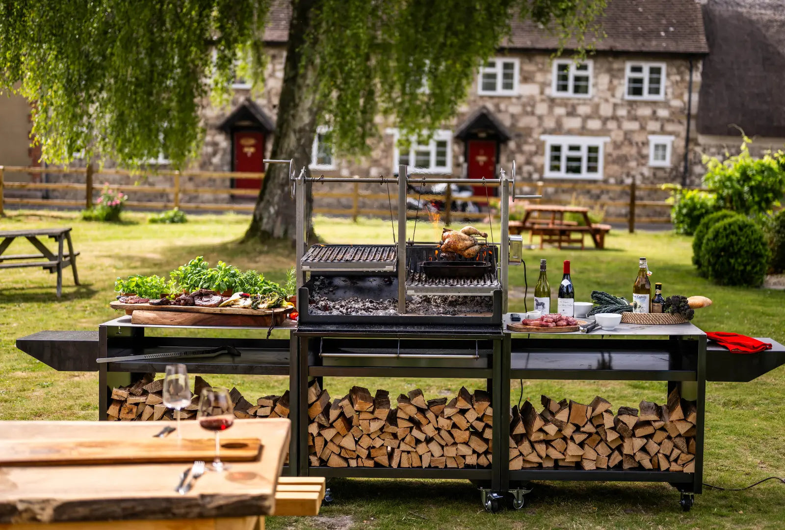 Grande Gunmetal outdoor kitchen bundle with charcoal grill, wood storage, and food preparation surfaces