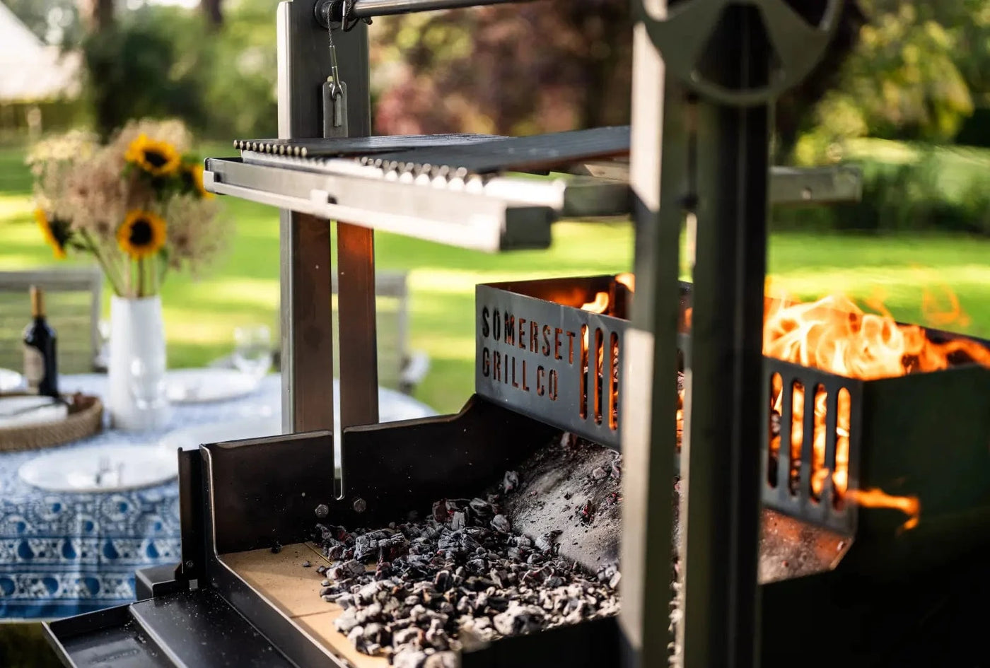 Stainless steel Somerset Grill Co. outdoor barbecue with glowing embers and flames